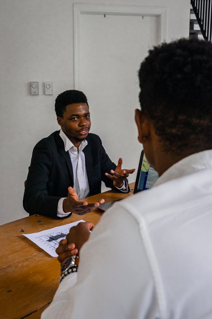Two professionals engaging in a focused discussion during a business meeting.